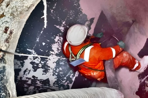 NQIS team member working in a the confined space of a silo